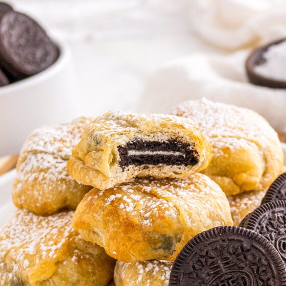 a bite out of an Oreo cookie wrapped in crescent dough and baked to a golden brown color
