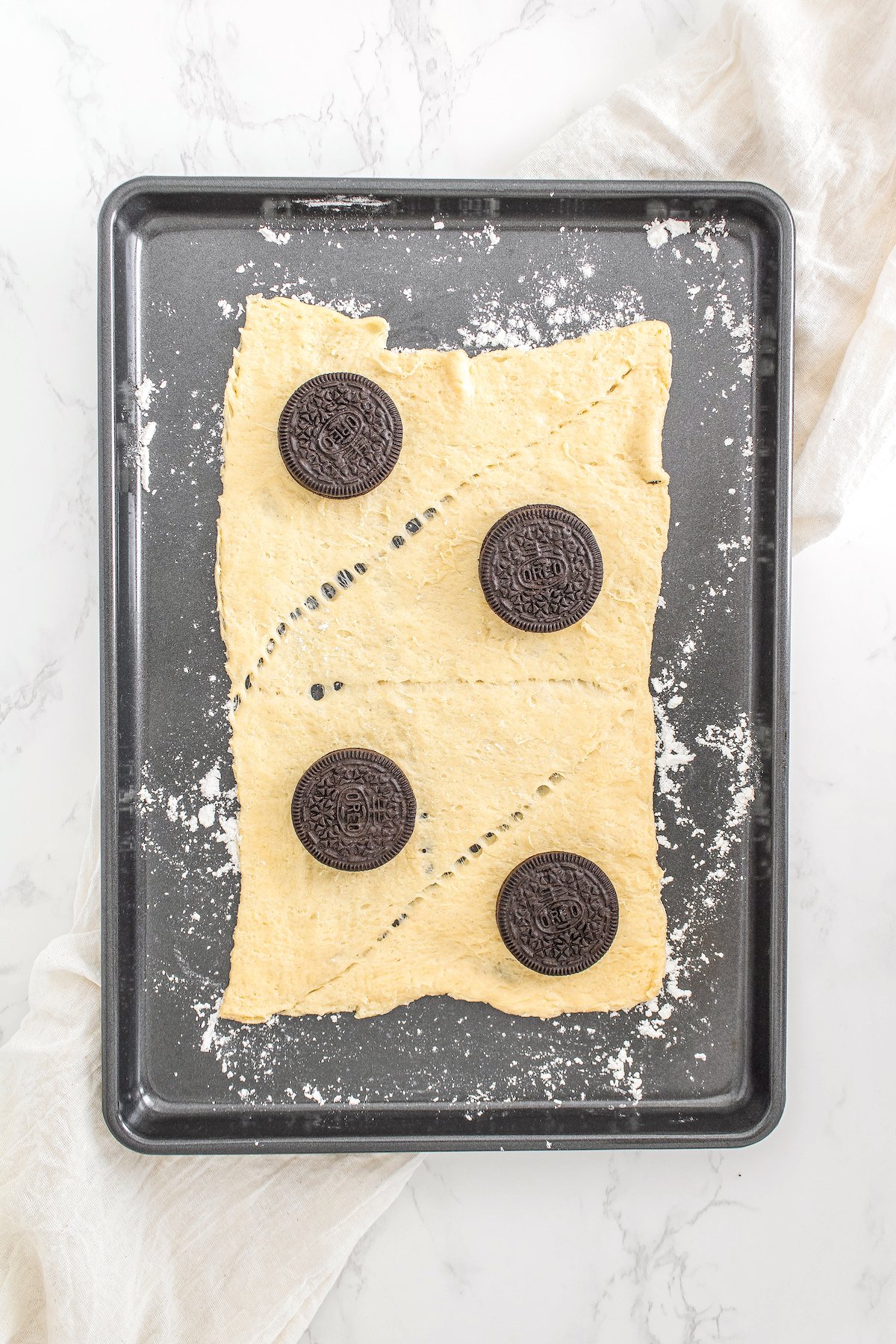 four crescent roll triangles with one Oreo laid on each roll