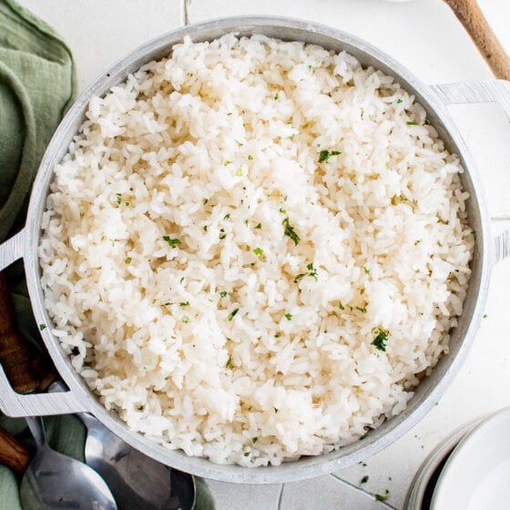 fluffy white rice in a dutch oven fresh herbs