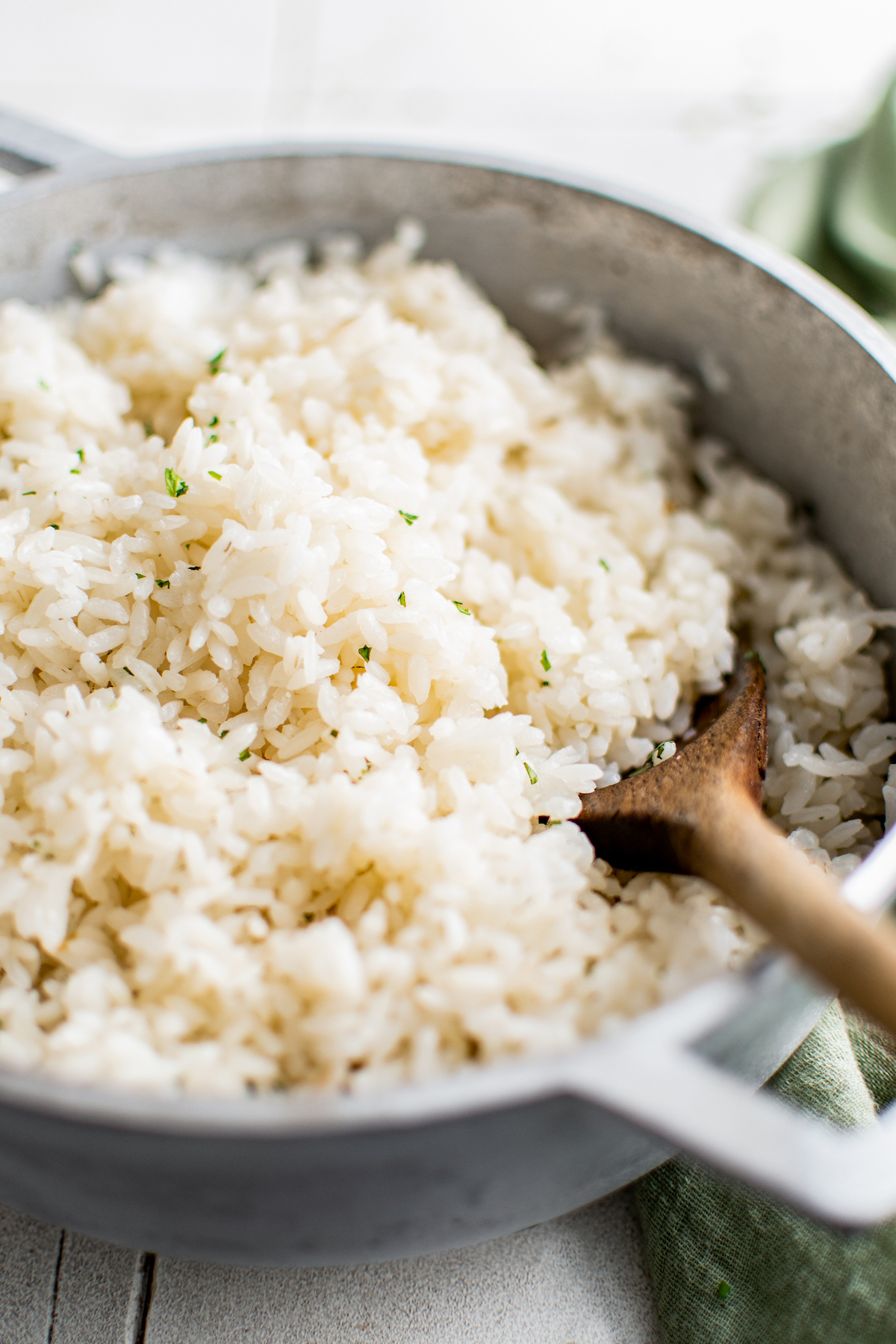 fluffy white rice in a dutch oven fresh herbs