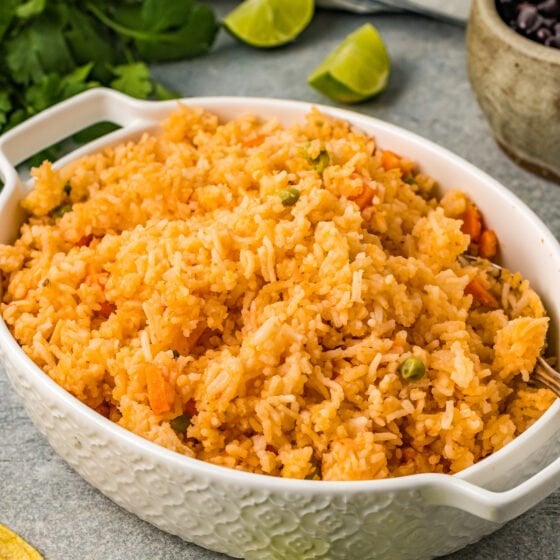 An oval casserole dish filled with fluffy, golden-orange rice.