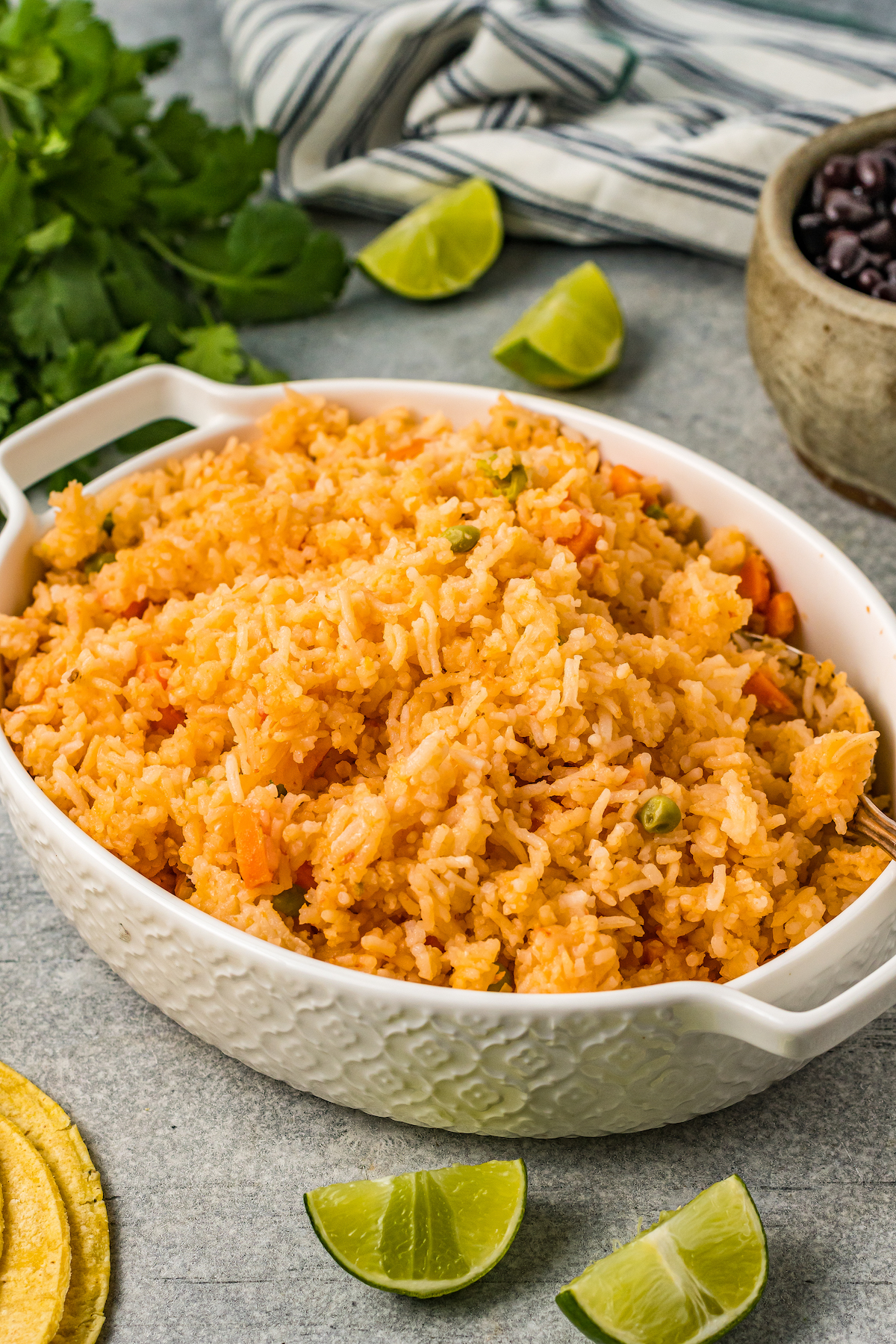 An oval casserole dish filled with fluffy, golden-orange rice.