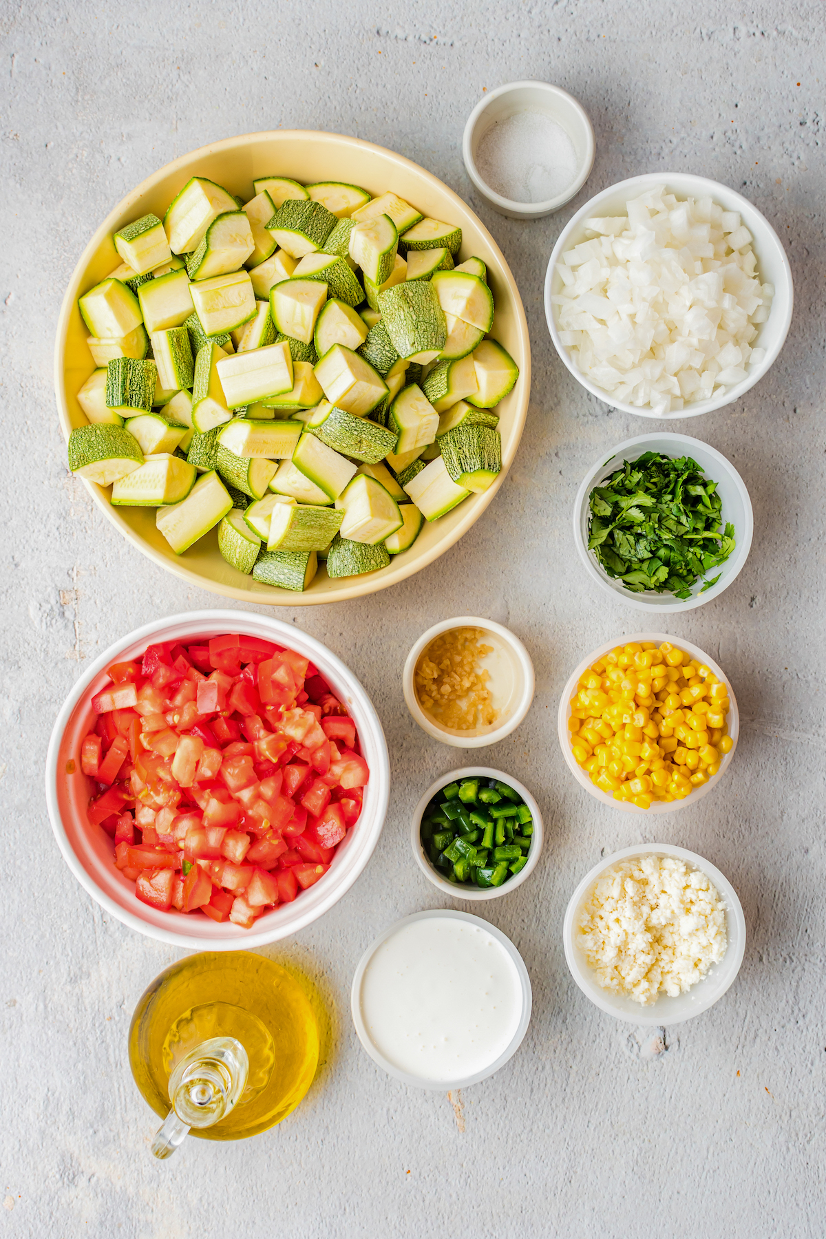 From top: Cubed squash, salt, diced onion, diced tomato, garlic, minced jalapeno, cilantro, corn kernels, olive oil, crema, queso fresco.