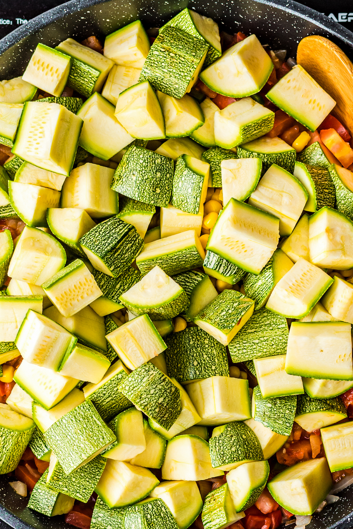 A skillet filled with vegetables.