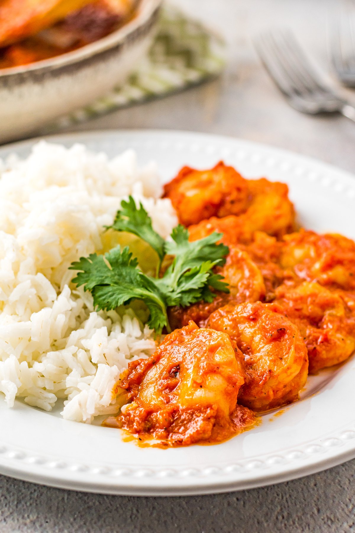 Camarones a la diabla with a side of white rice, on a white dinner plate.