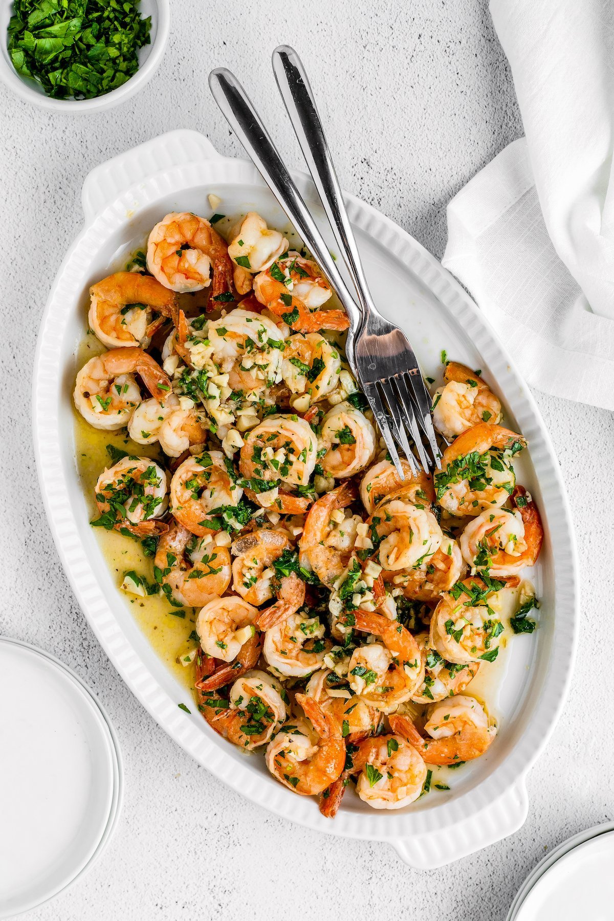 Garlic shrimp on an oval serving dish.
