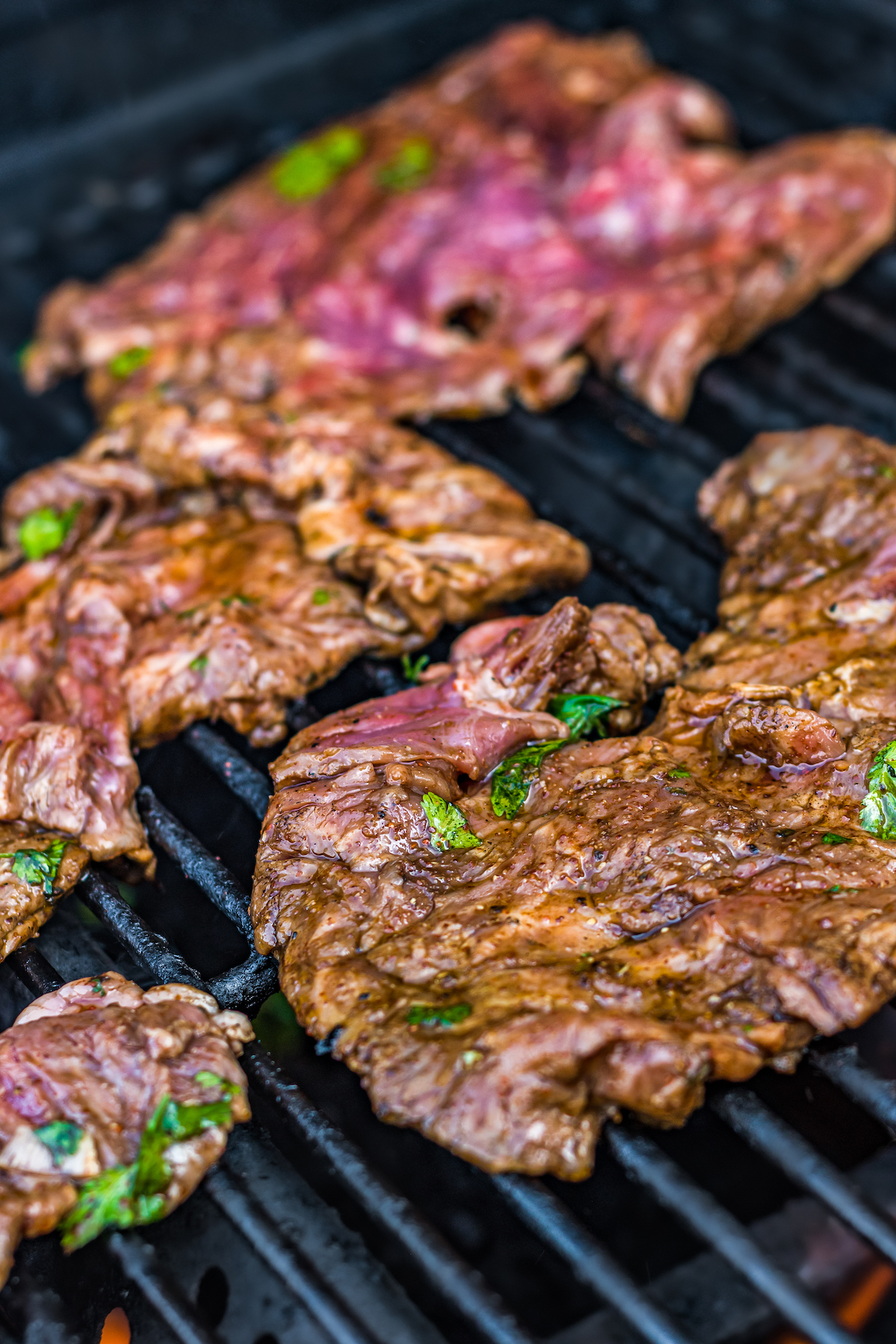 Steak cooking on a grill.