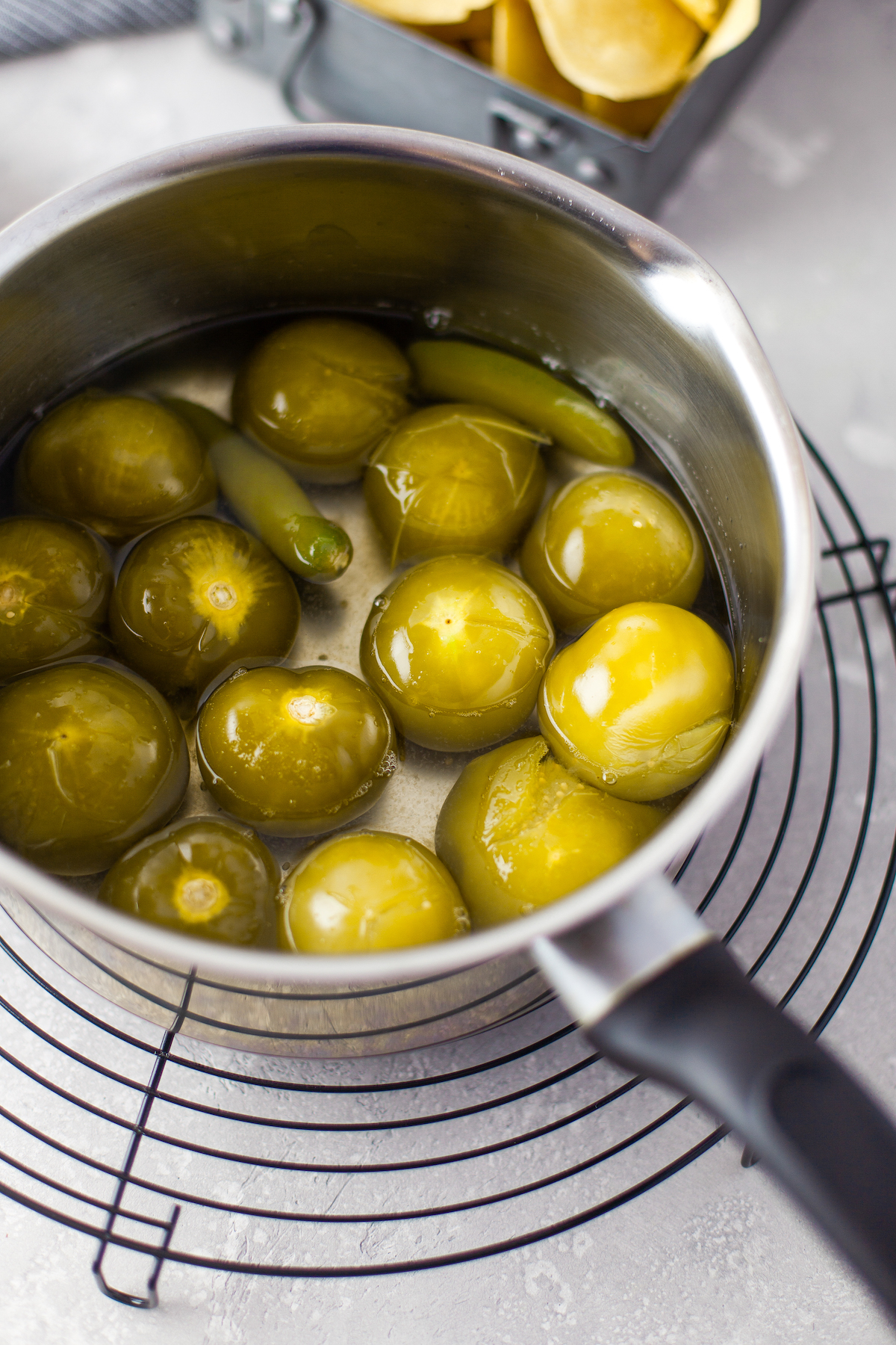 boiled tomatillos and peppers in a pan 