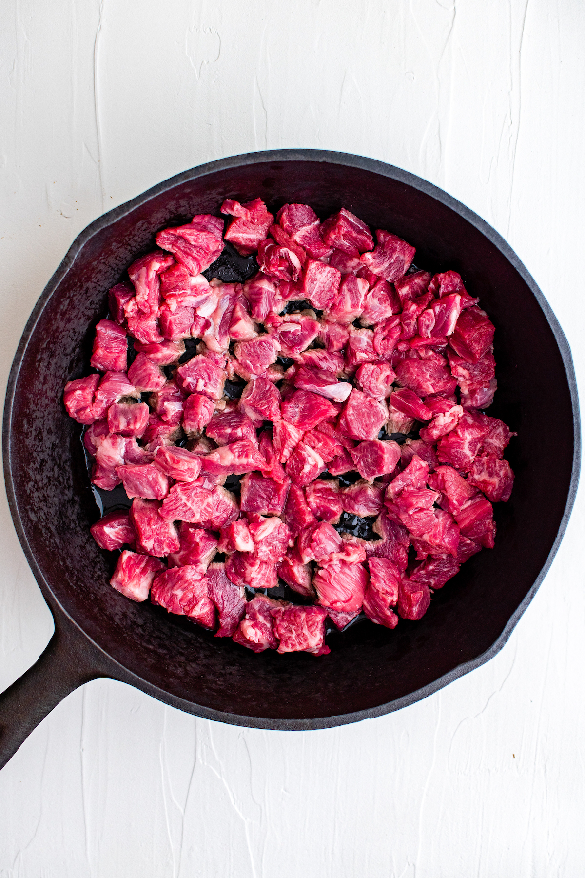 small pieces of beef in a cast iron skillet