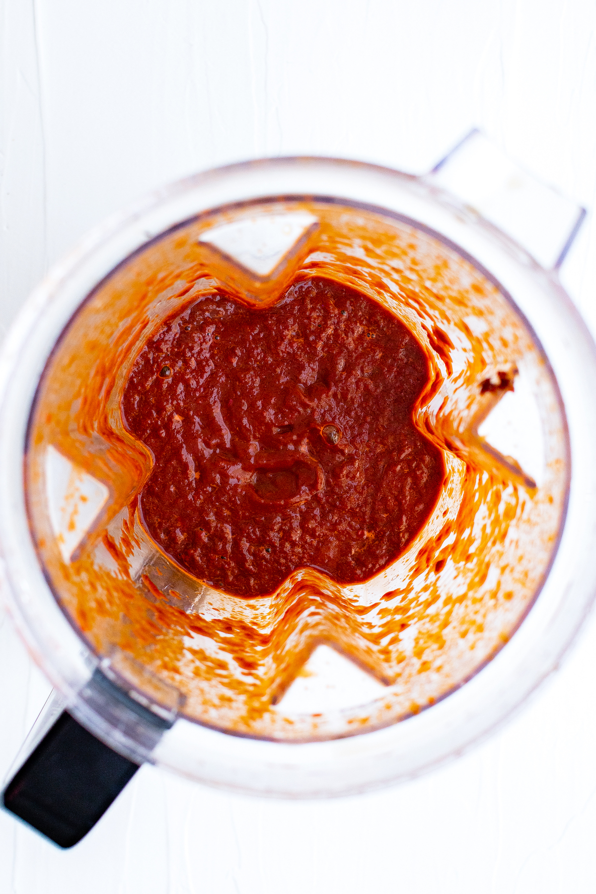 Red chili puree being blended in a blender