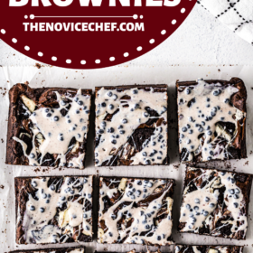 Cookies and cream brownies on parchment paper cut into pieces.