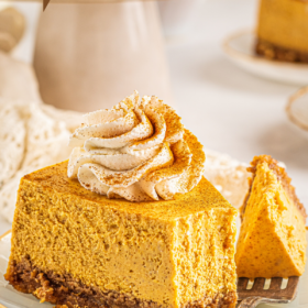 A slice of pumpkin cheesecake with a fork taking a bite.