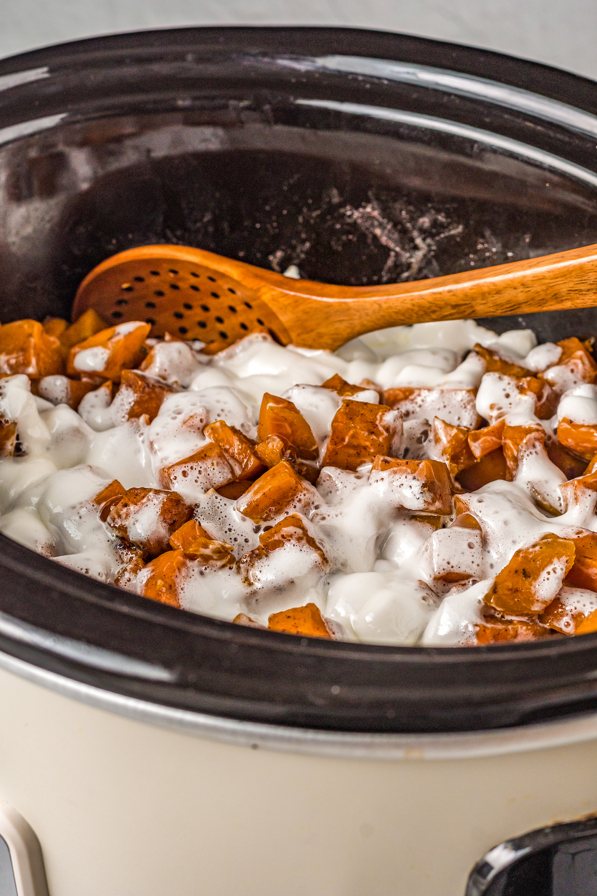 cubed sweet potatoes with melted mini marshmallows on top in a crockpot