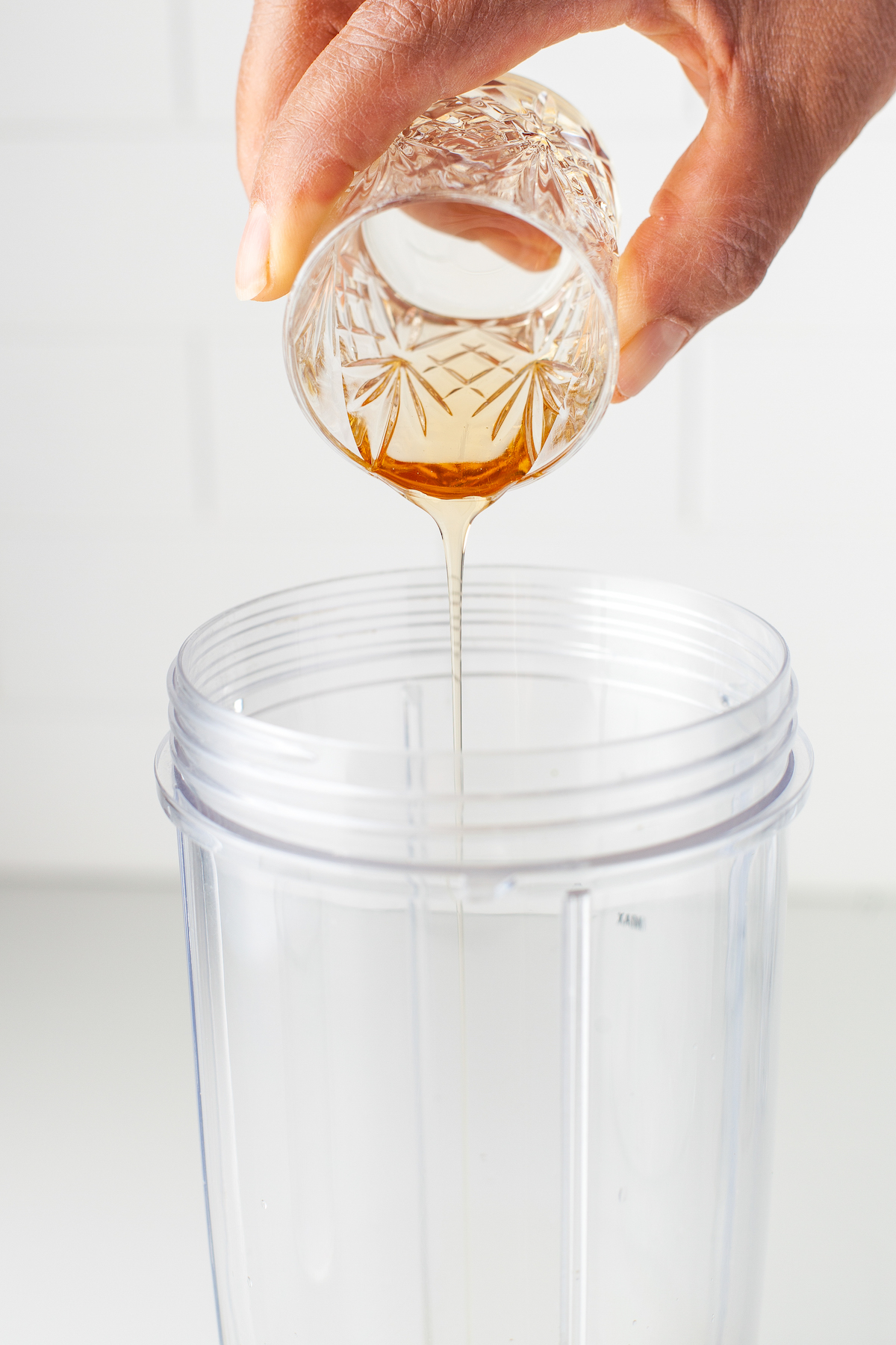 pouring liquor into a blender cup