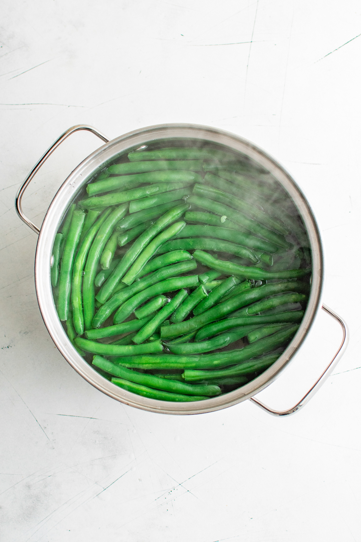 green beans being blanched in a pot