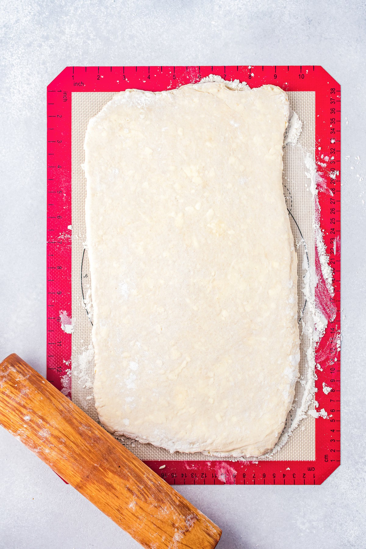 rolled pastry dough flat on a silcone mat