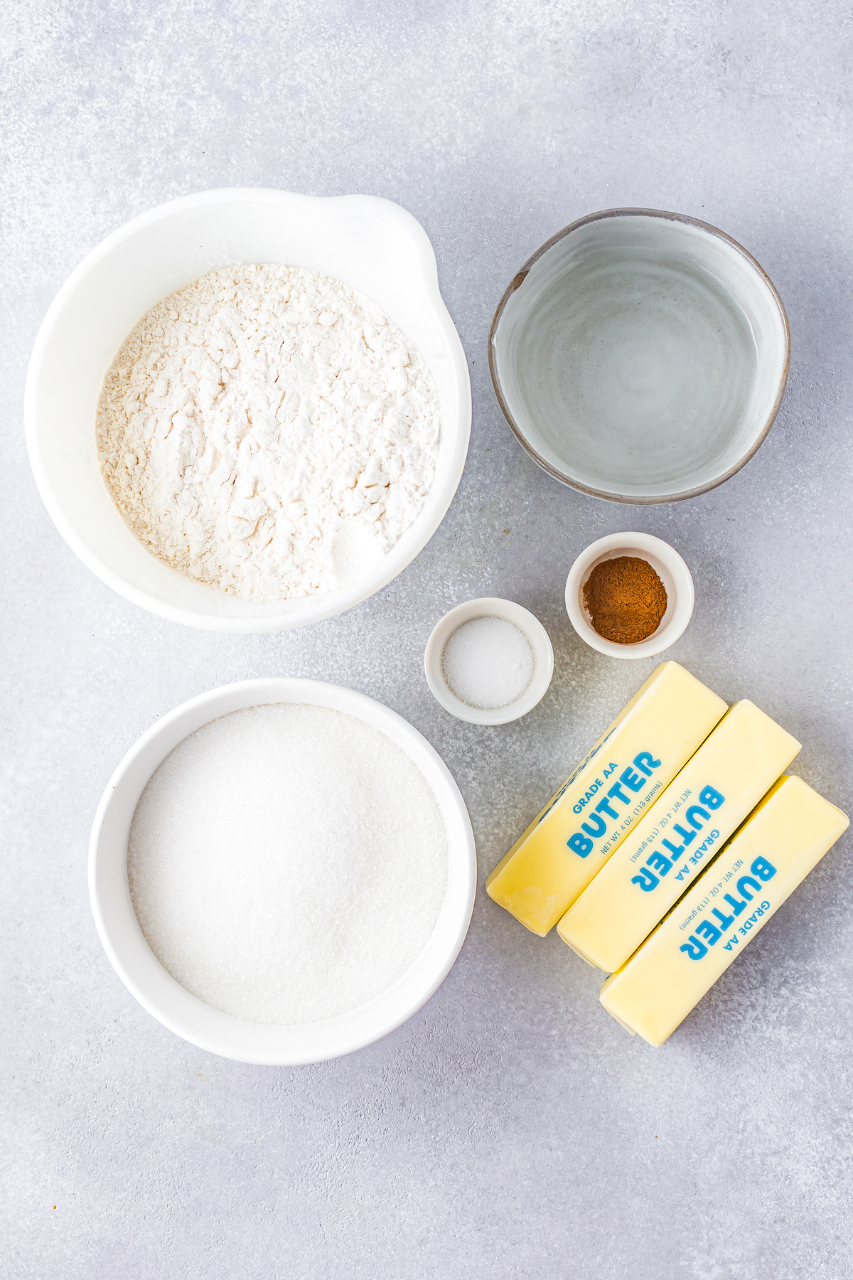 ingredients to make pastry dough including flour, butter, water, and cinnamon