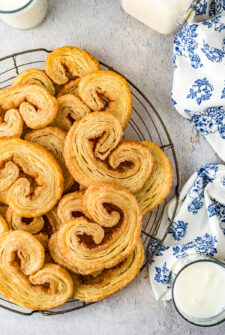a plate of orejas (palmiers), which are small pastry cookies that are golden brown and have curled edges