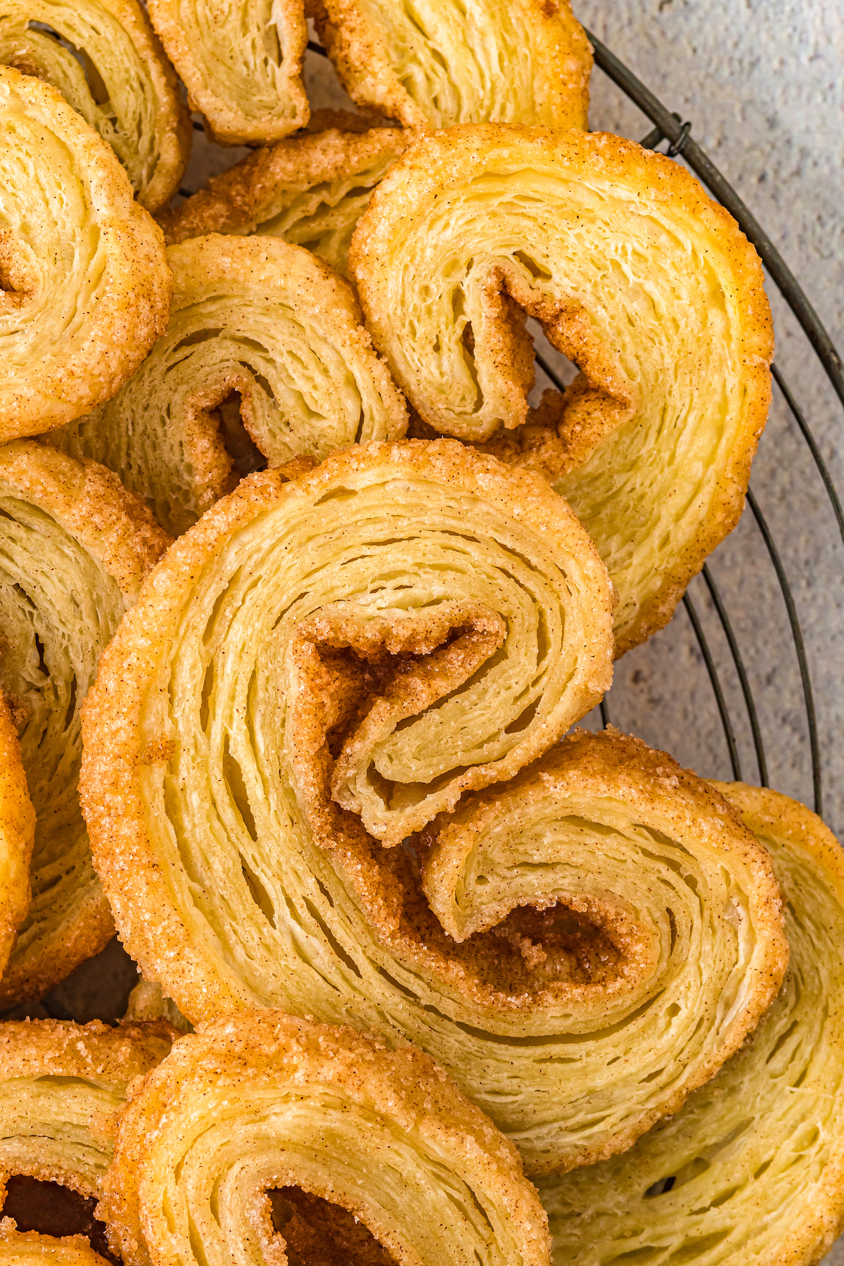 Small pastry cookies that are golden brown and have curled edges