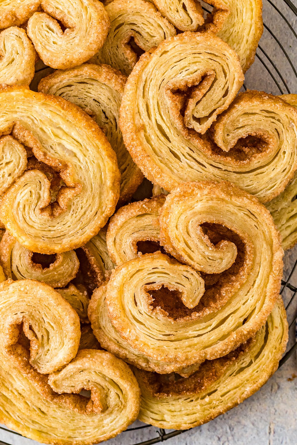 Small pastry cookies that are golden brown and have curled edges