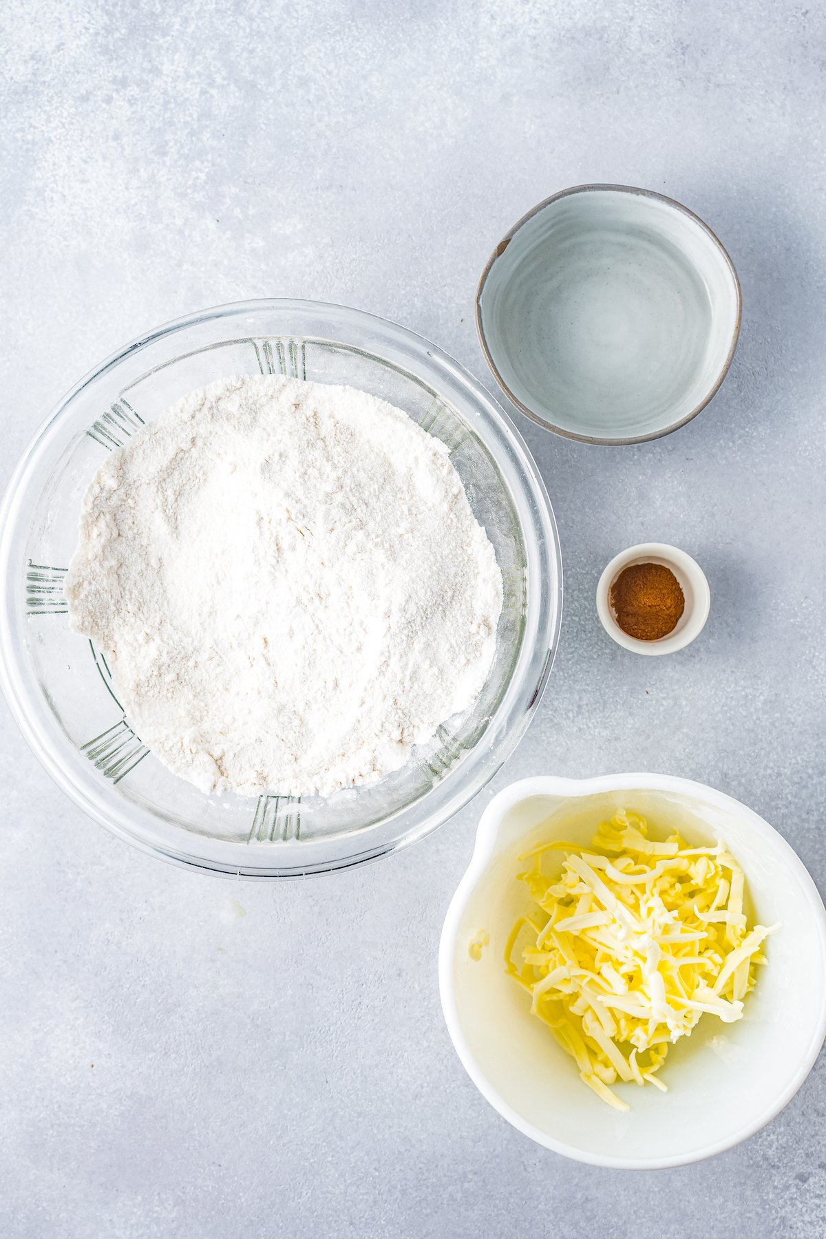 ingredients to make pastry dough including flour, shredded butter, water, and cinnamon