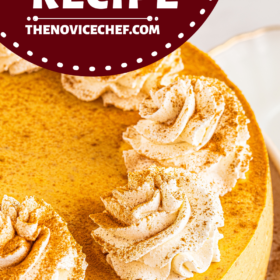 A whole pumpkin cheesecake with whip cream on top.
