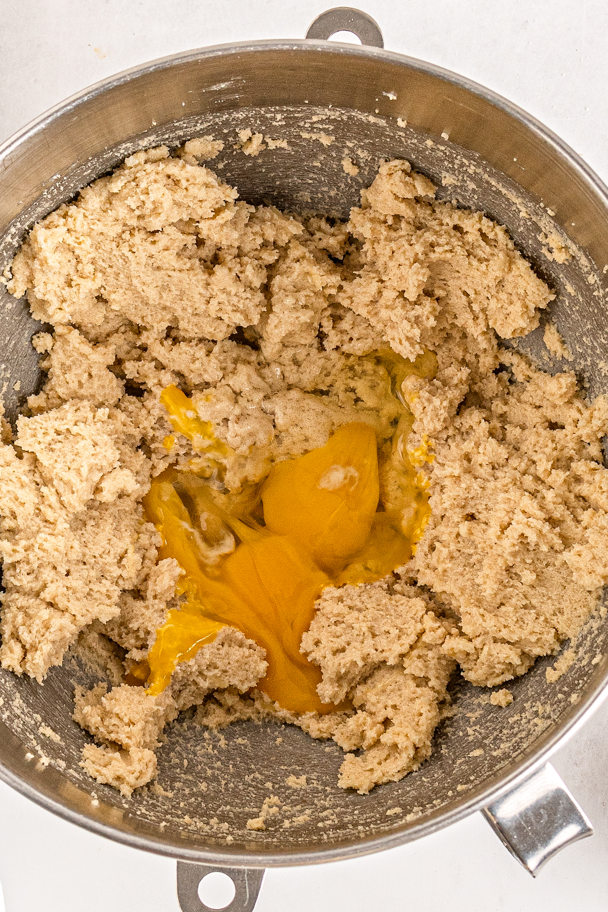 cookie dough with eggs in a large mixing bowl