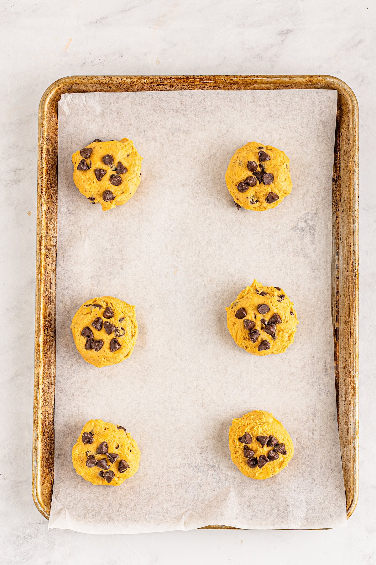 a sheet tray with chocolate chip pumpkin cookies