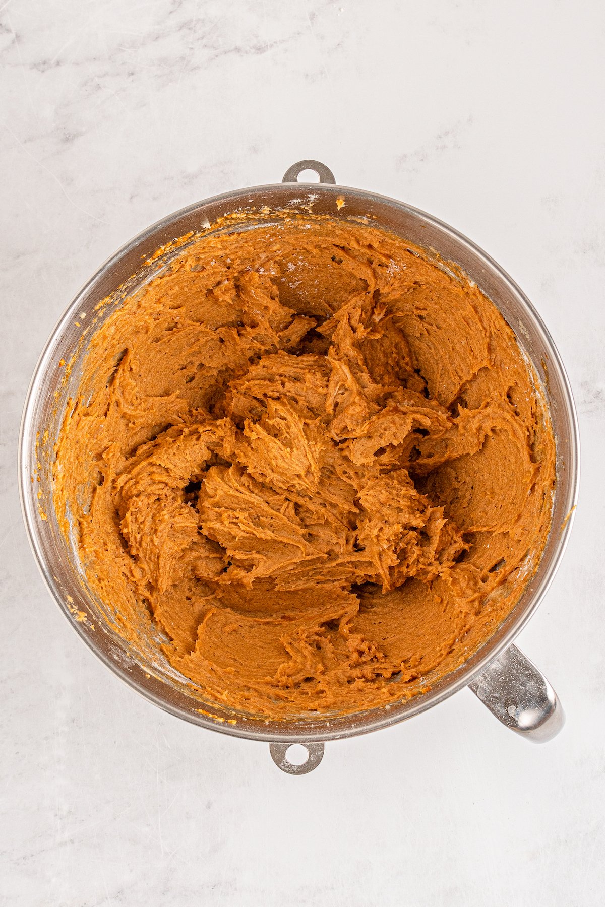 A fully mixed bowl of pumpkin cookie batter.
