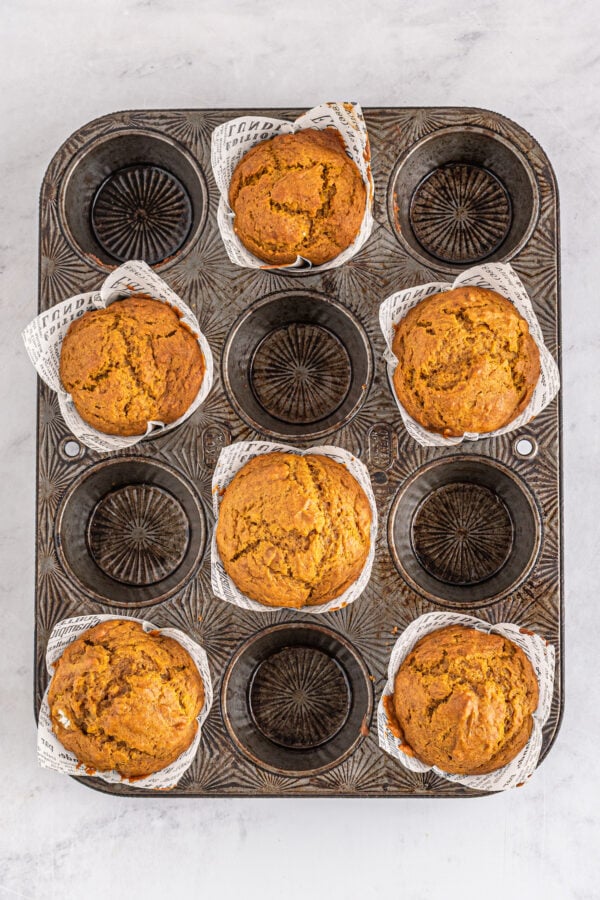 Baked pumpkin muffins in liners.