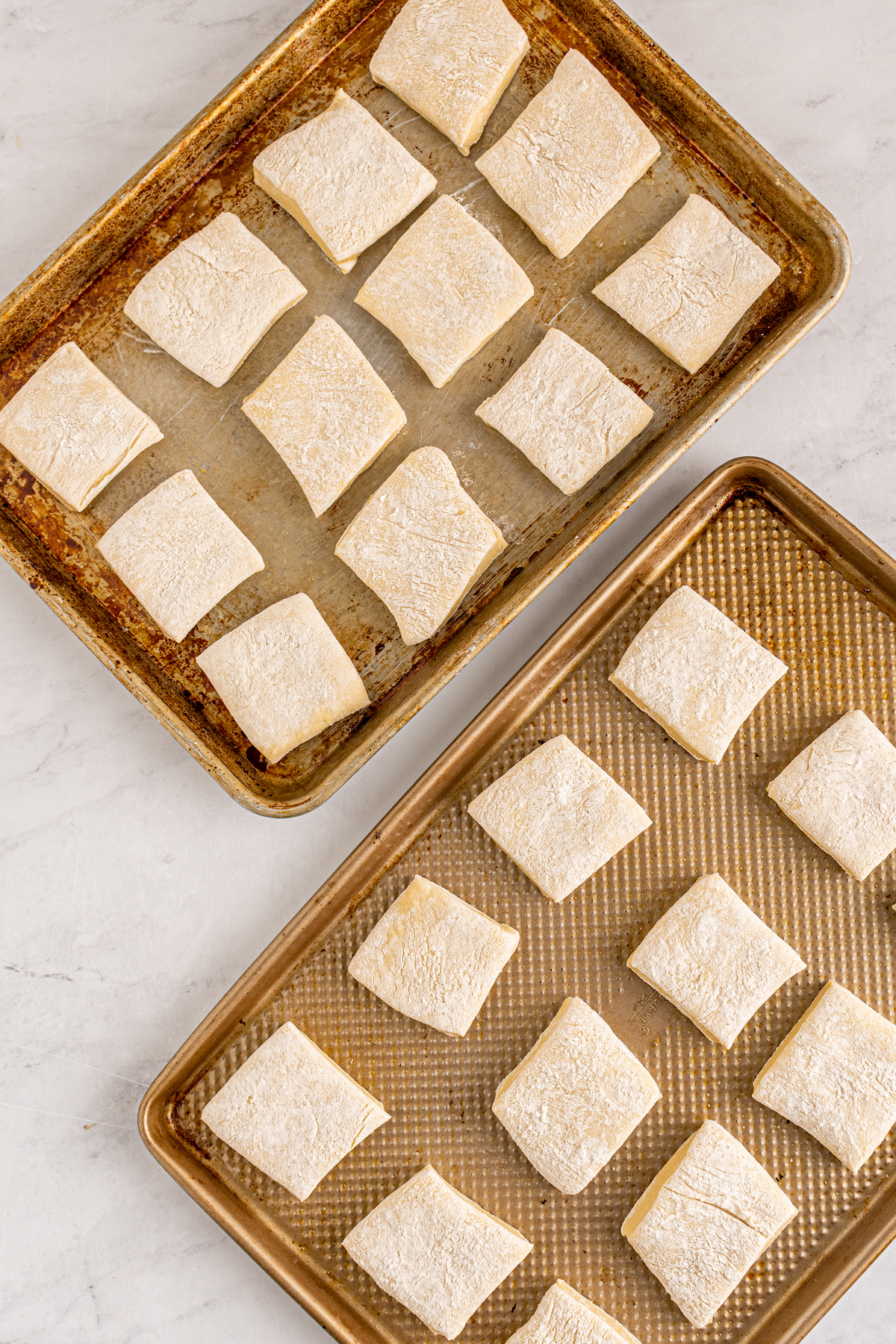 Squares of cut dough on baking sheets.