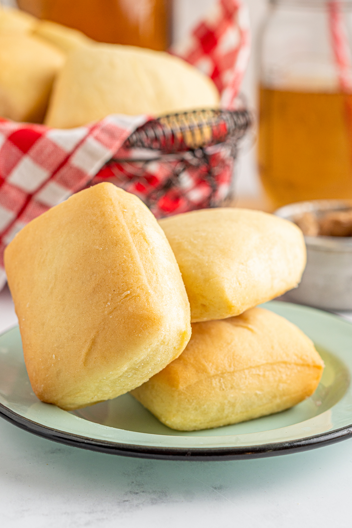 Soft, baked Texas Roadhouse rolls on a plate.