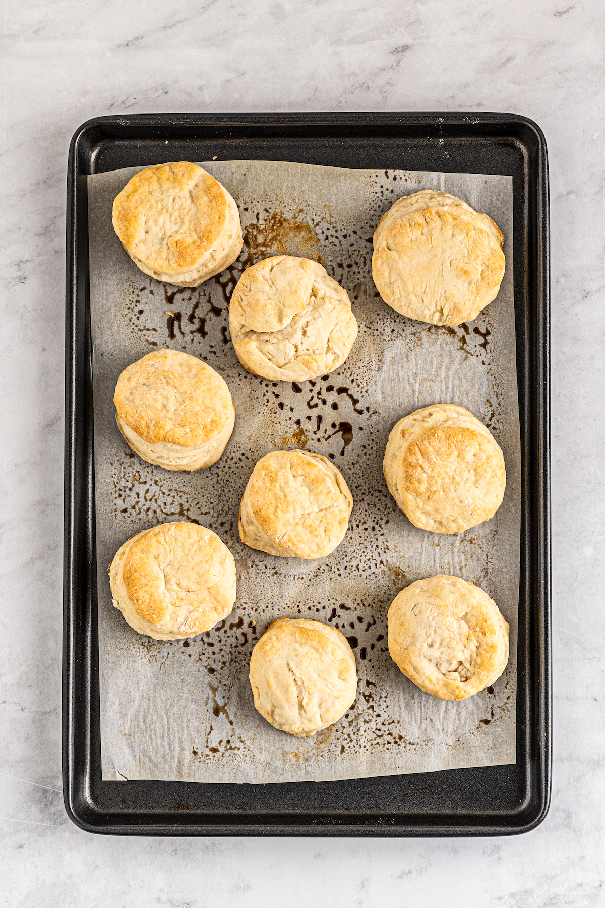 Baked, golden biscuits on a baking sheet.