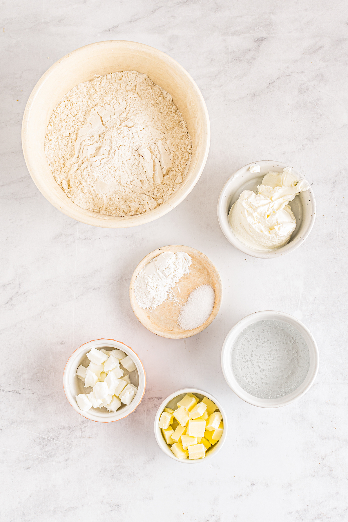 From top: Flour, sour cream, baking powder, salt, cubed shortening, cubed butter, 7-Up.