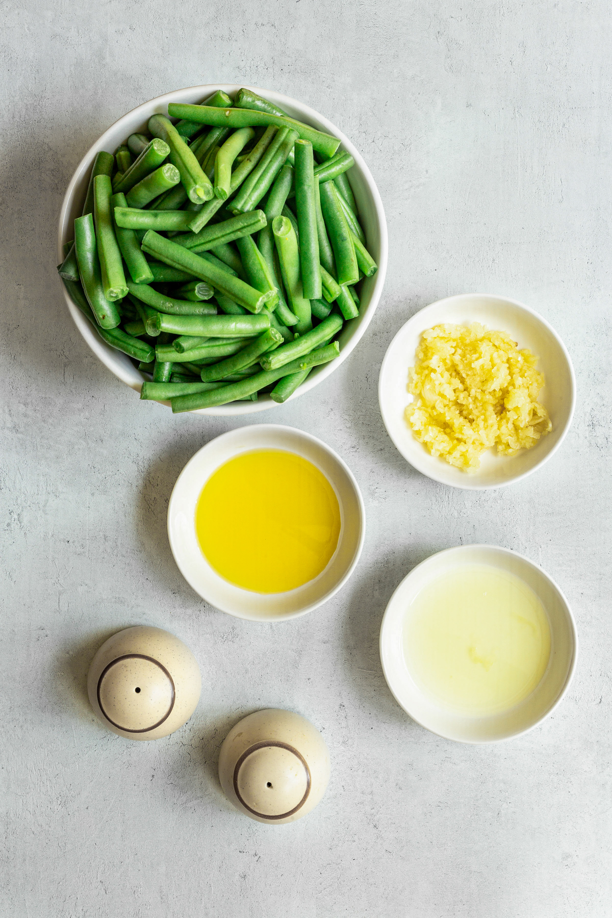 From top: Fresh green beans, minced garlic, lemon juice, salt, pepper, and olive oil.