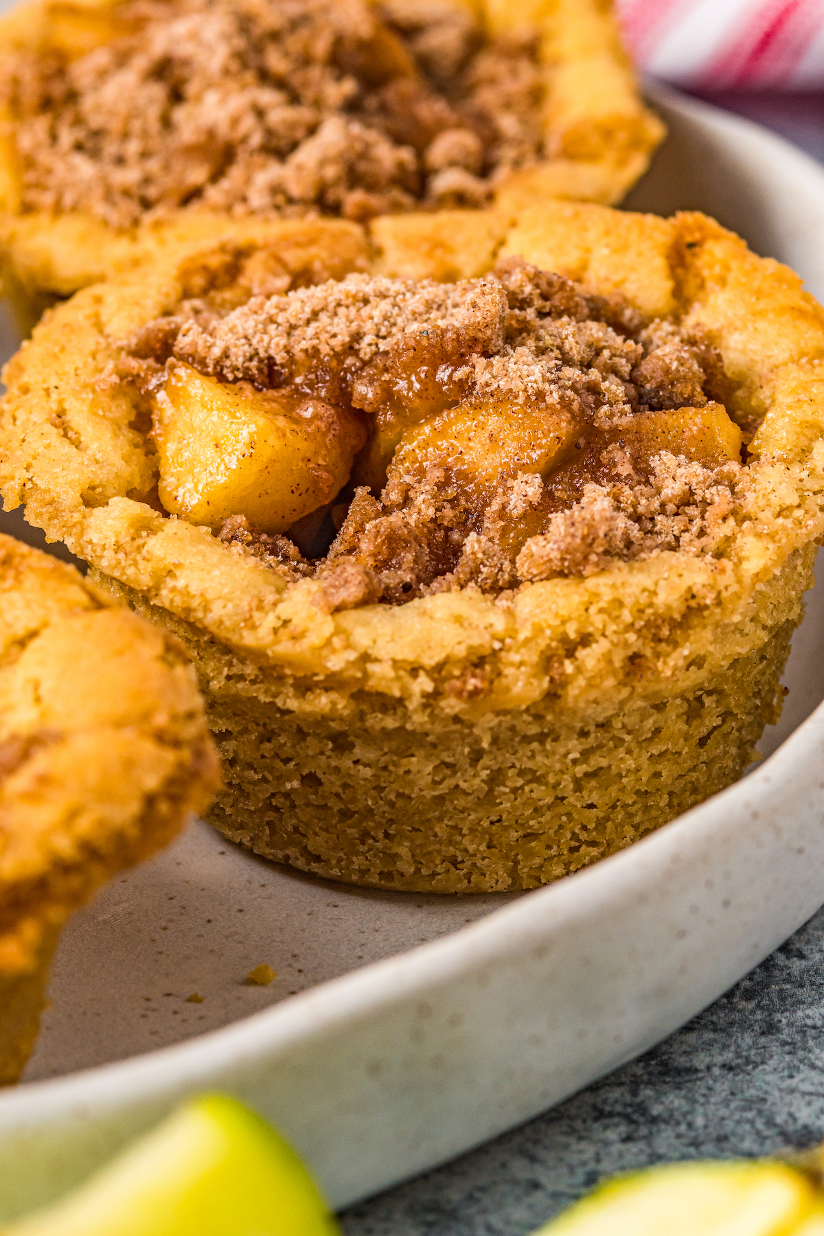 Close-up side view of mini apple pie cookie cups, showing the texture of the crust.