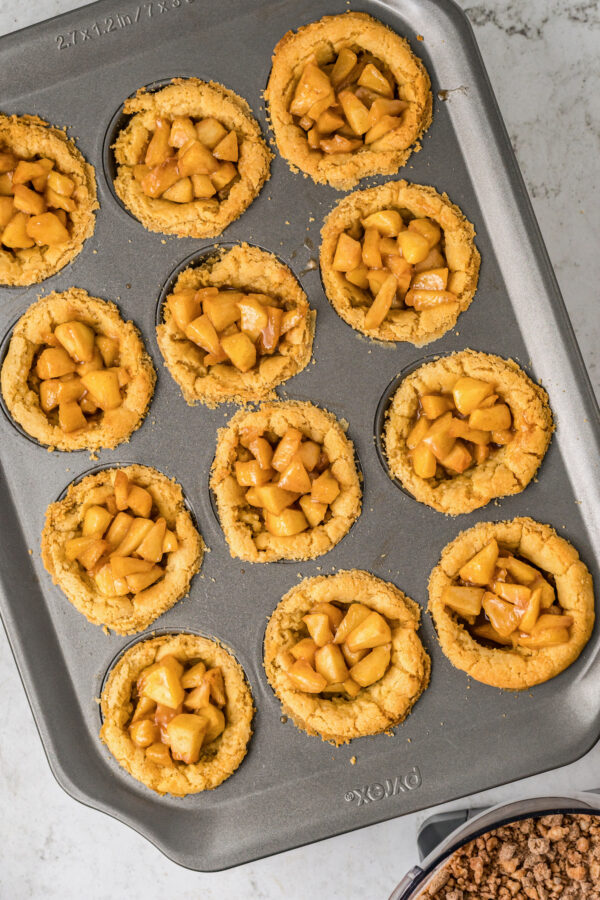 Cookie crusts filled with apple pie filling.