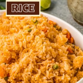 A bowl of authentic mexican rice with peas and carrots.