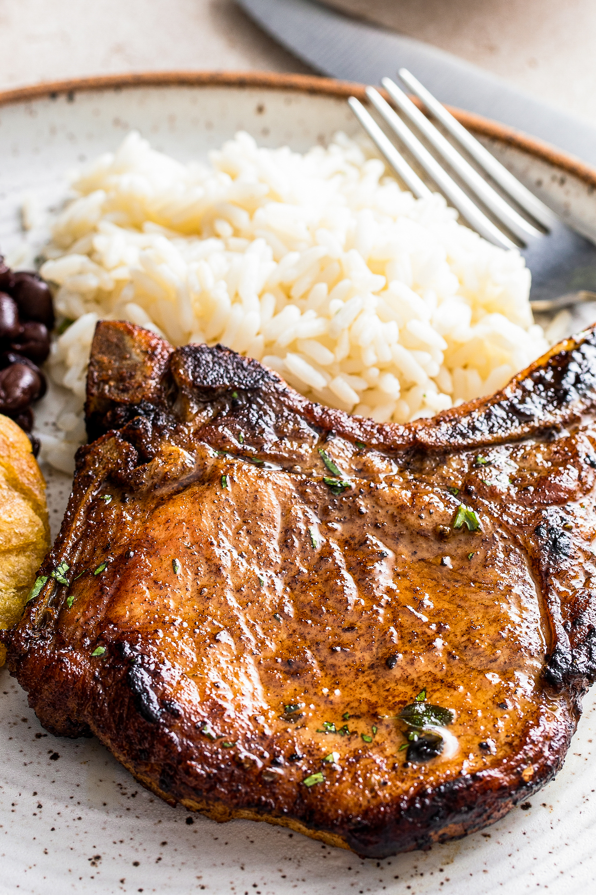 Chuleta frita on a plate with rice and beans