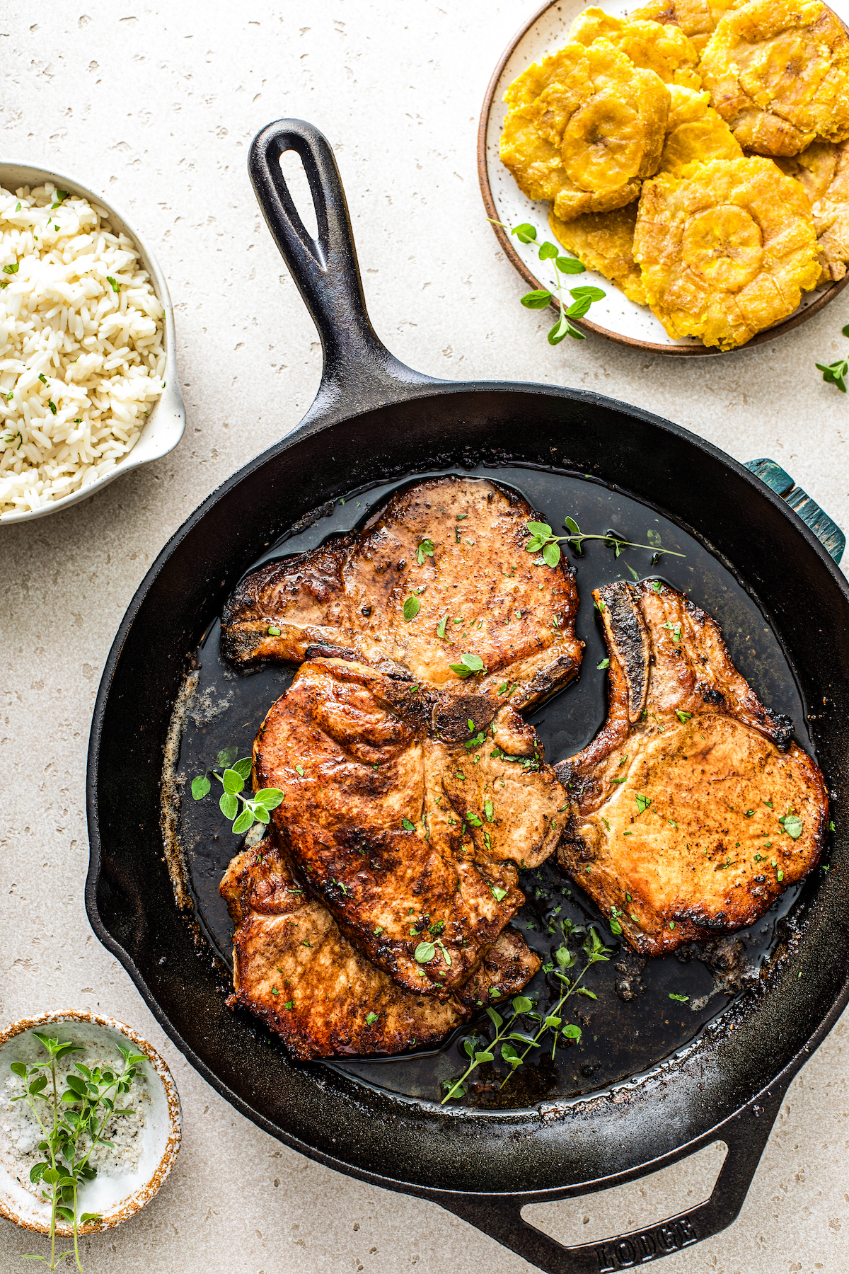 Pork chops frying in a skillet