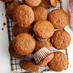 Gingerbread muffins on a wire cooling rack.