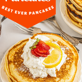 Lemon pancakes on a white plate with whip cream.