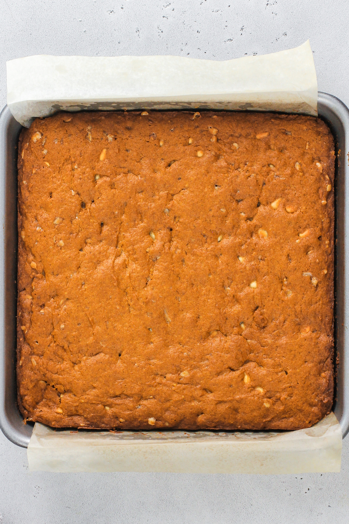 Baked pumpkin blondies in a square baking dish.