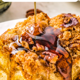 Breakfast french toast casserole with syrup being poured on top.