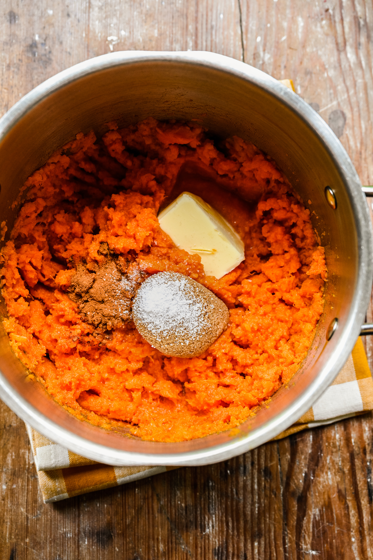 A pot of mashed sweet potatoes with brown sugar, salt, butter, and cinnamon added.