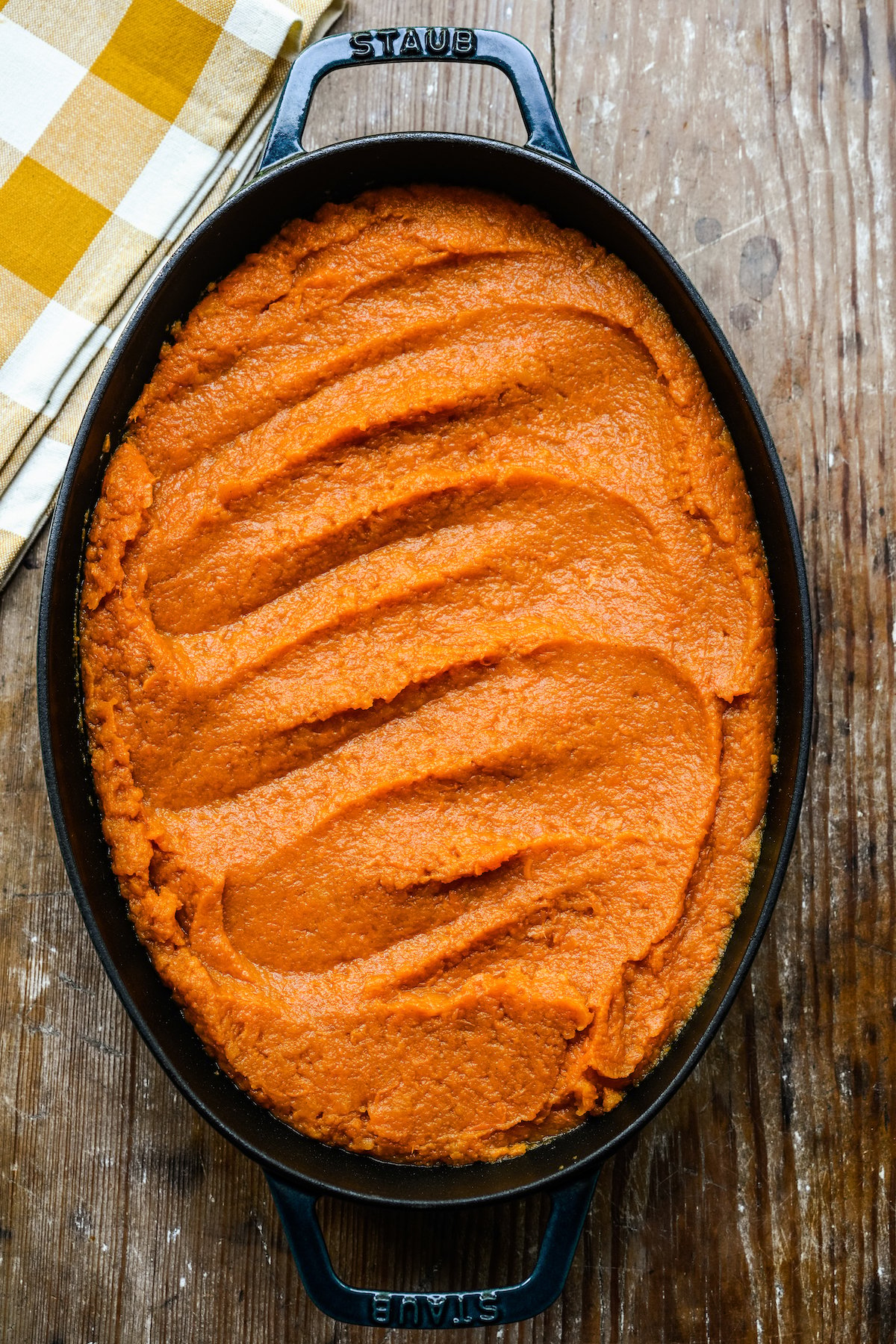 A casserole dish filled with mashed sweet potatoes.