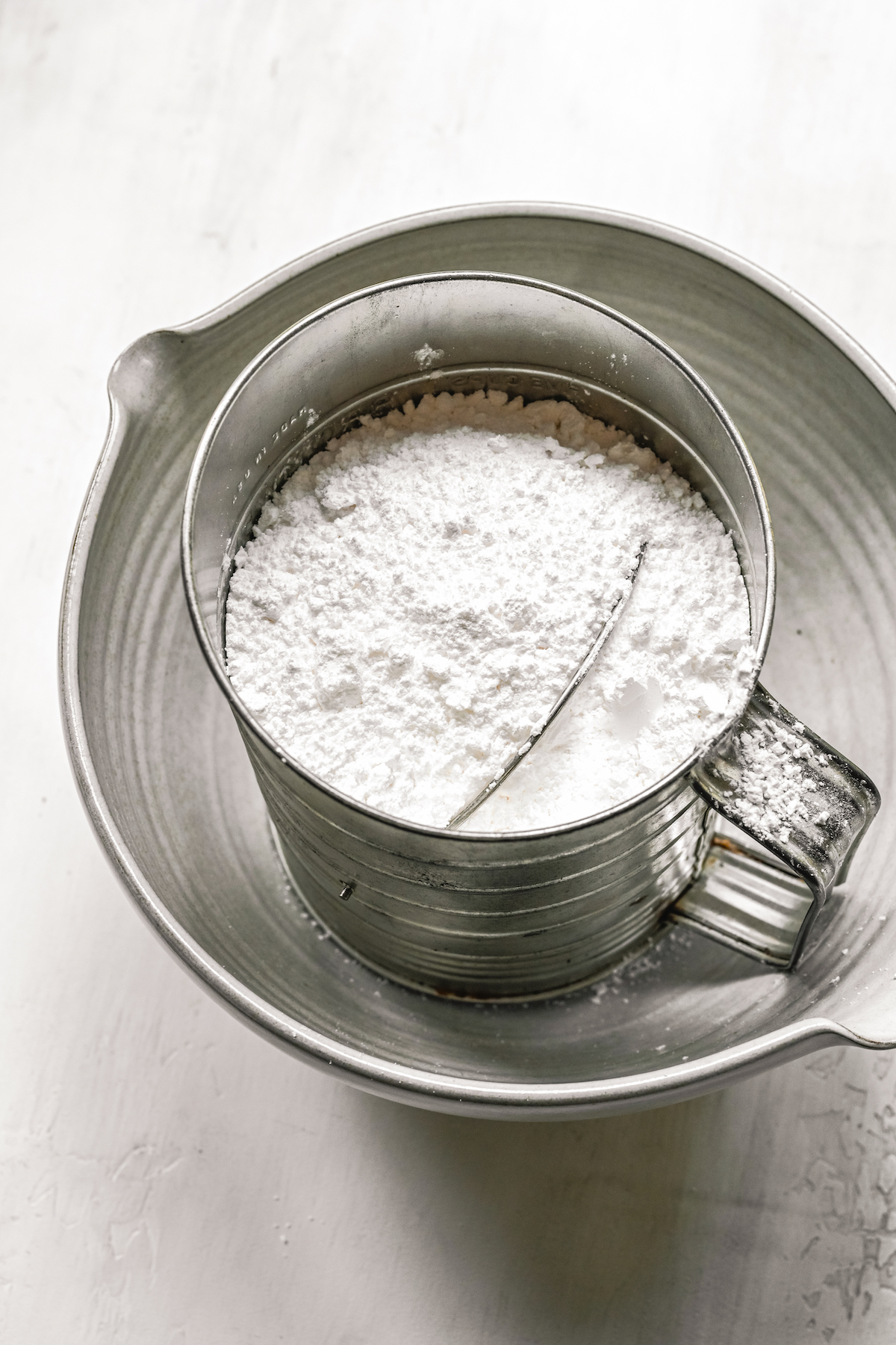 Powdered sugar in a sifter.
