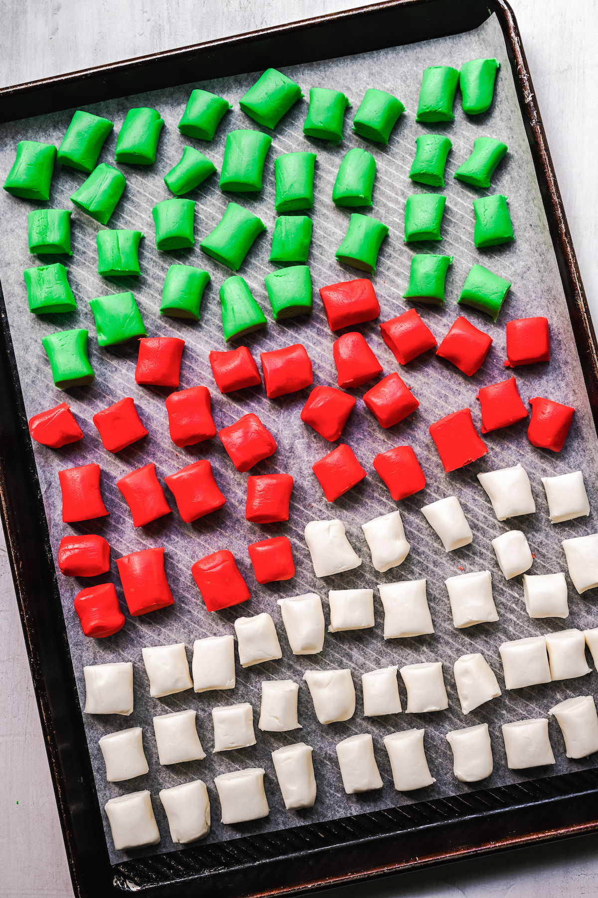 A tray of red, white, and green mints.