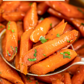 Sweet carrots with parsley on top with a spoon.