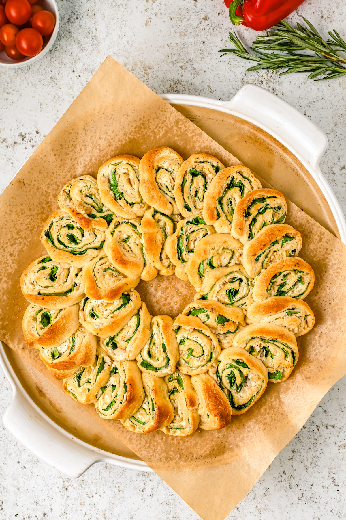 A baked pinwheel wreath made of crescent roll dough and filling.